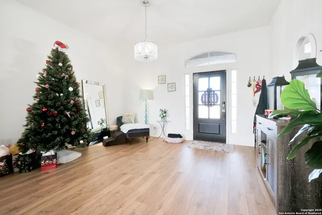 a living room with furniture and a christmas tree
