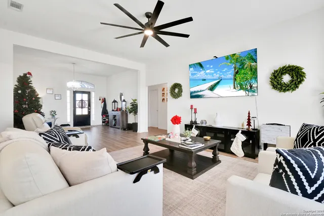 a living room with furniture and wooden floor