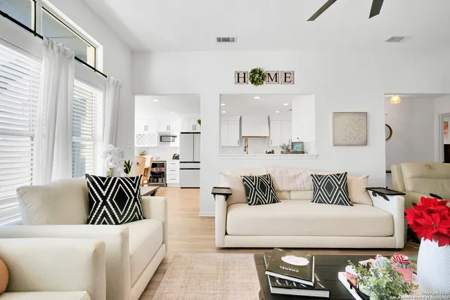a living room with furniture and a large window