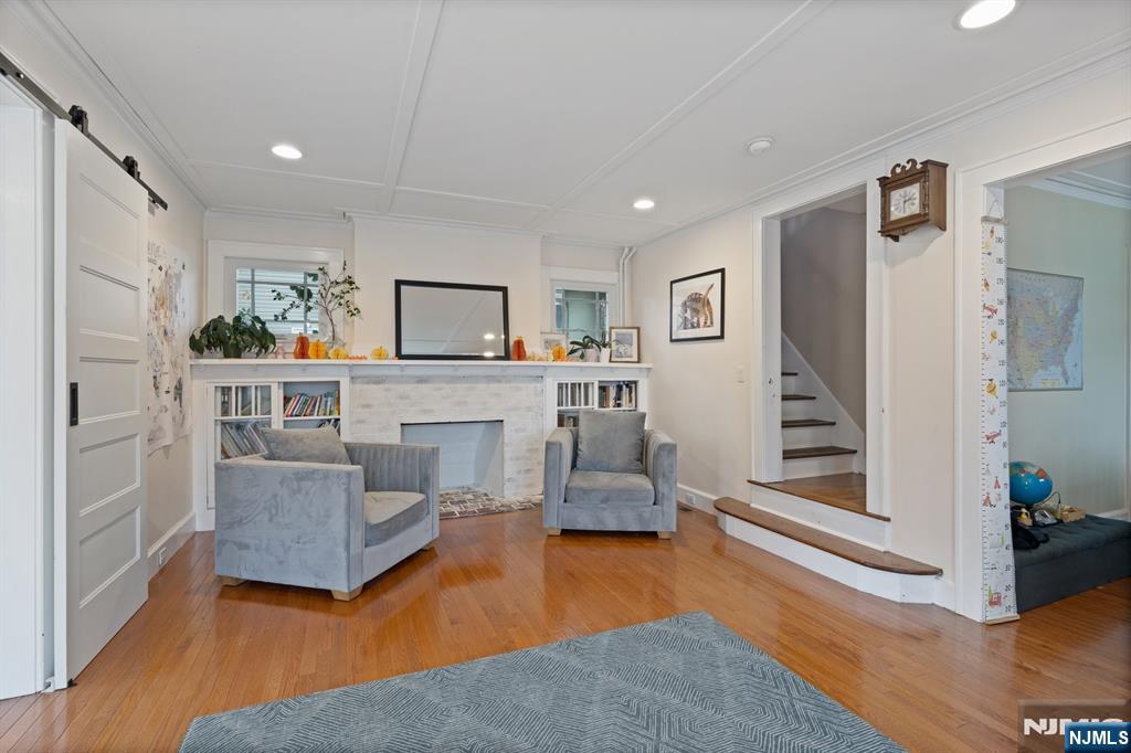 74 Kipp Avenue Hasbrouck Heights, NJ 07604 - Photo 11 of 28 a living room with furniture and a fireplace