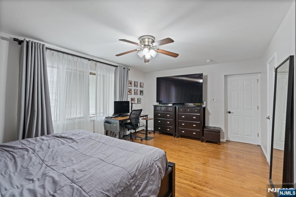 74 Kipp Avenue Hasbrouck Heights, NJ 07604 - Photo 13 of 28 a bedroom with a bed and a flat screen tv
