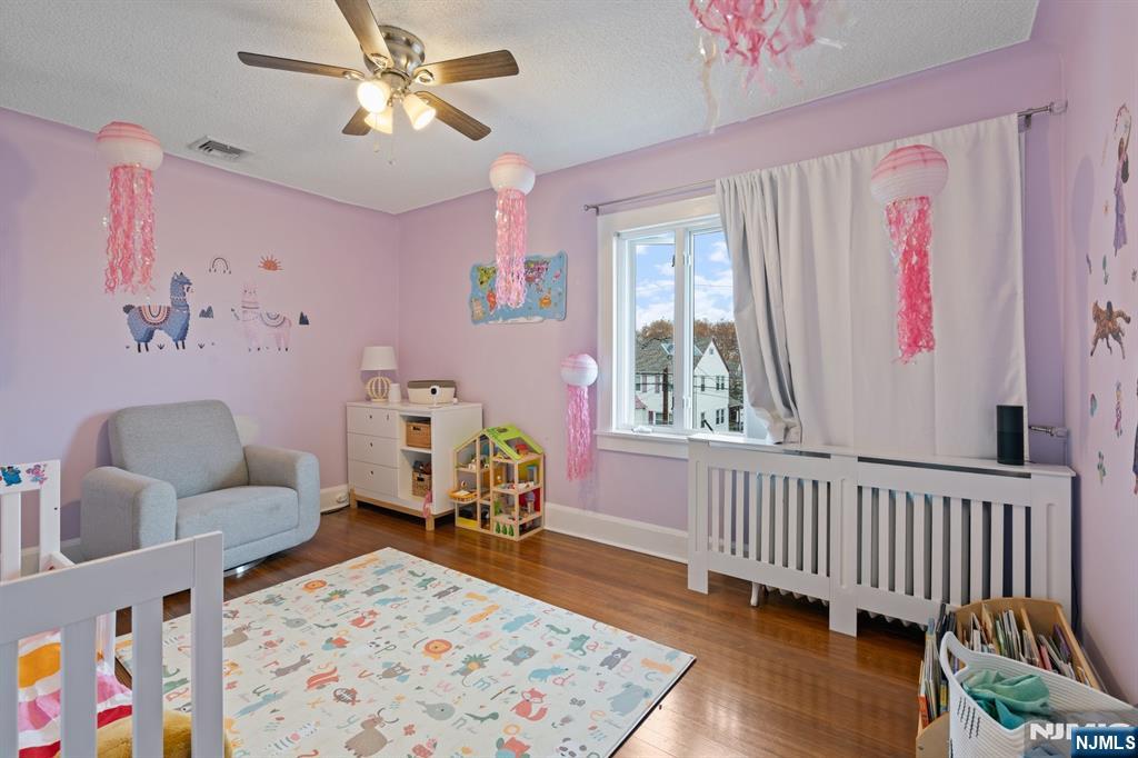 74 Kipp Avenue Hasbrouck Heights, NJ 07604 - Photo 16 of 28 a bedroom with furniture and wooden floor