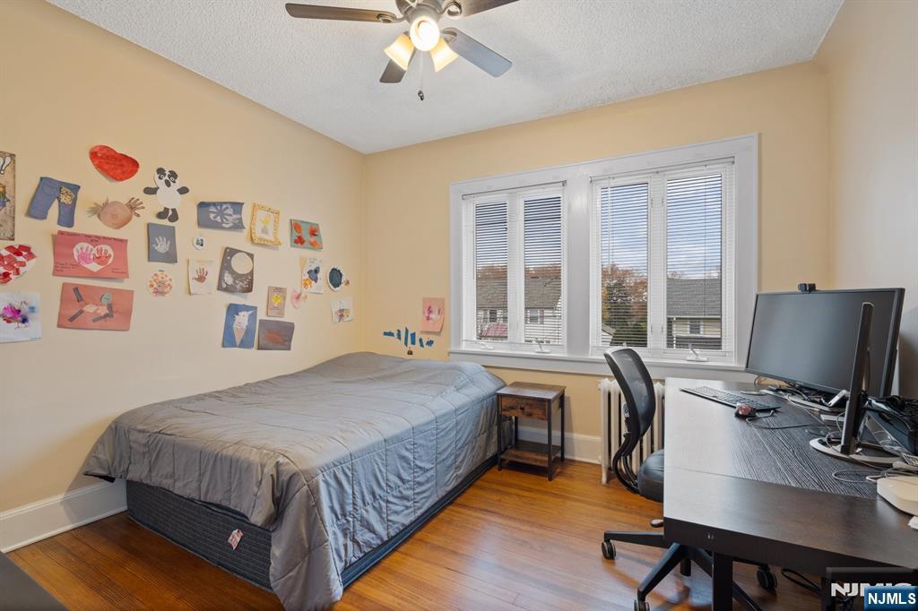 74 Kipp Avenue Hasbrouck Heights, NJ 07604 - Photo 17 of 28 a bed room with a bed and a desk