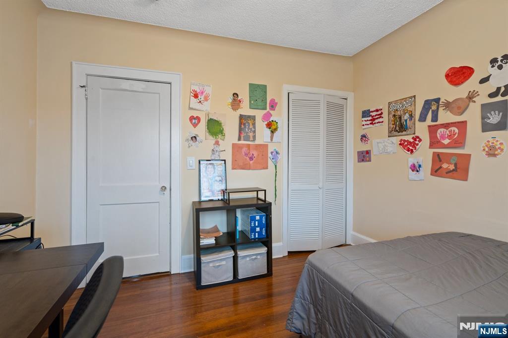 74 Kipp Avenue Hasbrouck Heights, NJ 07604 - Photo 18 of 28 a bedroom with a bed and a workspace