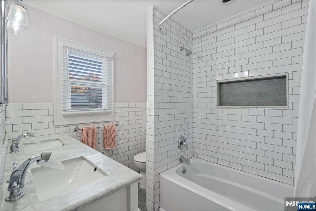 74 Kipp Avenue Hasbrouck Heights, NJ 07604 - Photo 19 of 28 a bathroom with a sink and a bathtub