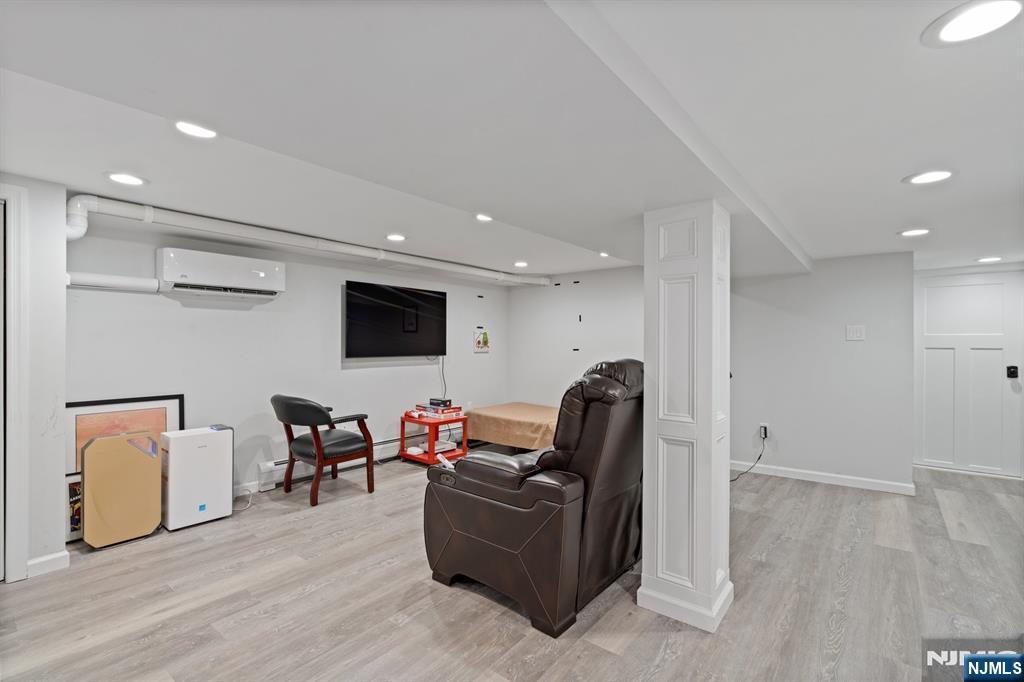74 Kipp Avenue Hasbrouck Heights, NJ 07604 - Photo 25 of 28 a living room with furniture and a flat screen tv