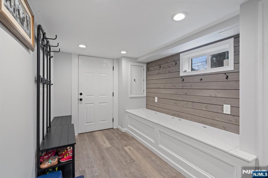 74 Kipp Avenue Hasbrouck Heights, NJ 07604 - Photo 27 of 28 a view of a hallway to a room with wooden floor and cabinet