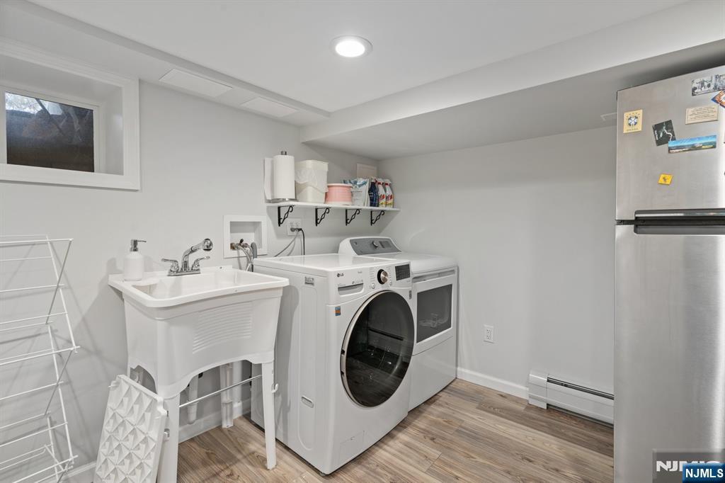 74 Kipp Avenue Hasbrouck Heights, NJ 07604 - Photo 28 of 28 a utility room with sink dryer and washer