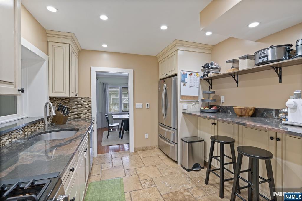 74 Kipp Avenue Hasbrouck Heights, NJ 07604 - Photo 4 of 28 a kitchen with granite countertop a sink appliances and cabinets