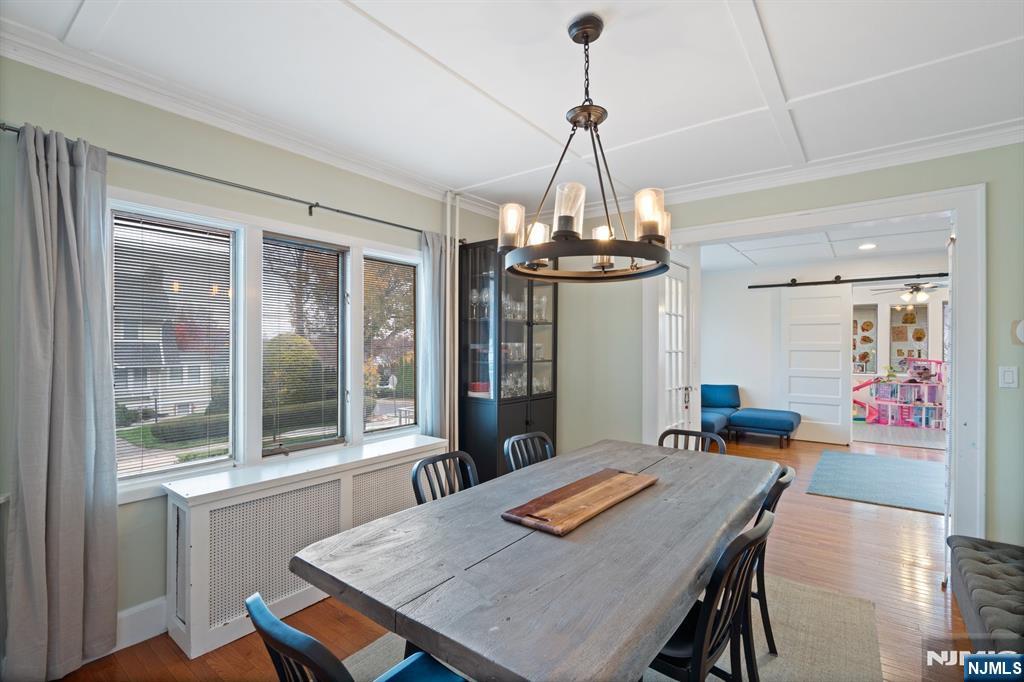74 Kipp Avenue Hasbrouck Heights, NJ 07604 - Photo 7 of 28 a view of a dining room with furniture wooden floor livingroom and chandelier
