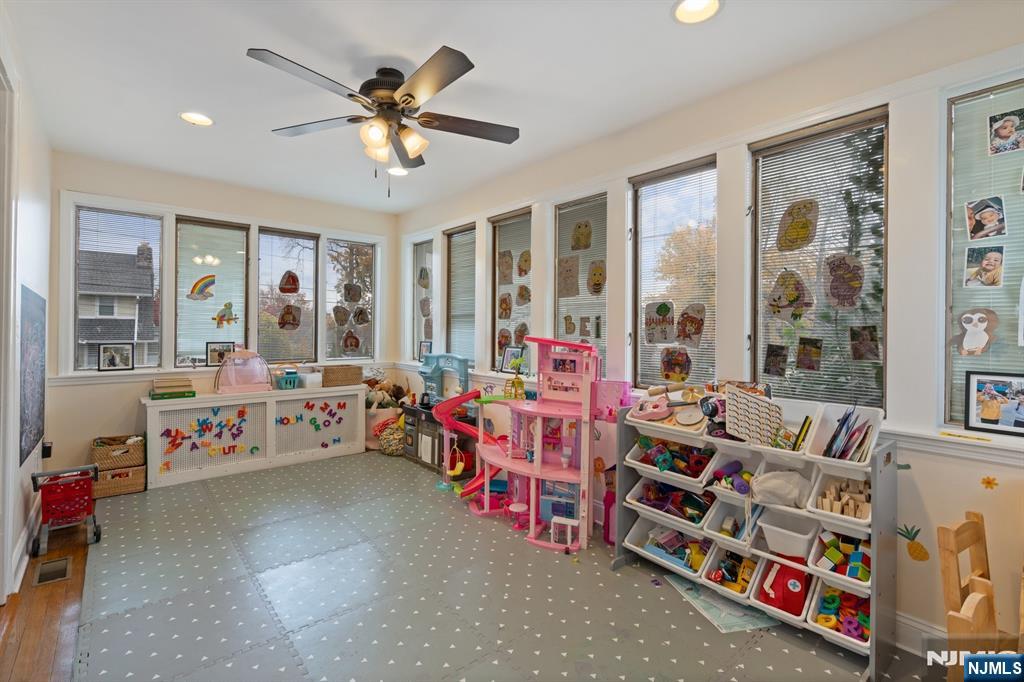 74 Kipp Avenue Hasbrouck Heights, NJ 07604 - Photo 8 of 28 a living room with lots of furniture and a chandelier