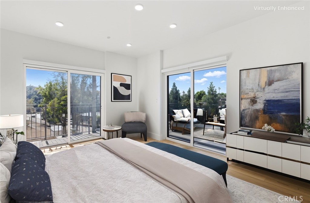 12078 Guerin Street, Unit 406 Studio City, CA 91604 - Photo 1 of 16 a bedroom with a bed and large glass window