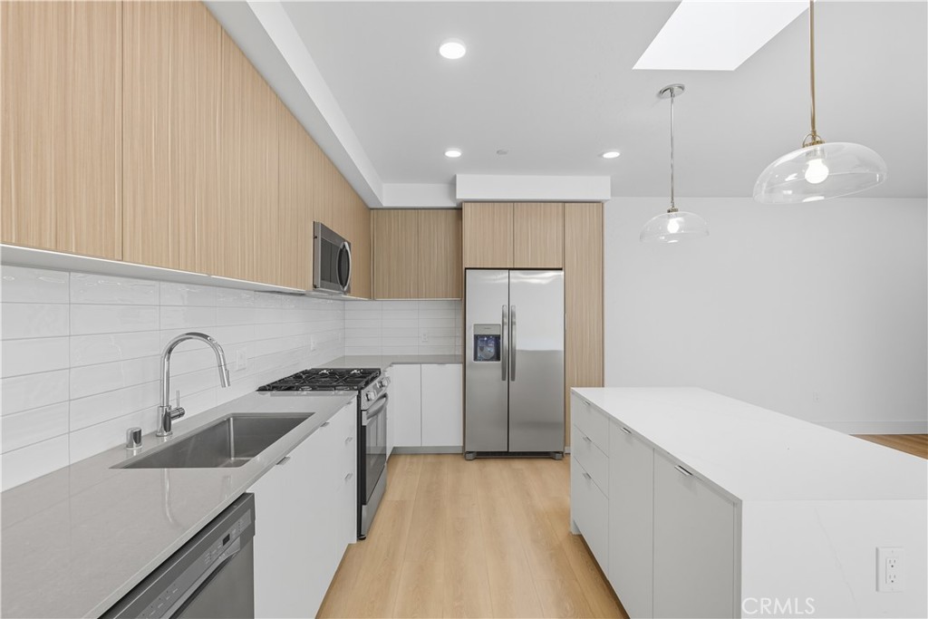 12078 Guerin Street, Unit 406 Studio City, CA 91604 - Photo 5 of 16 a kitchen with a sink a refrigerator and a stove