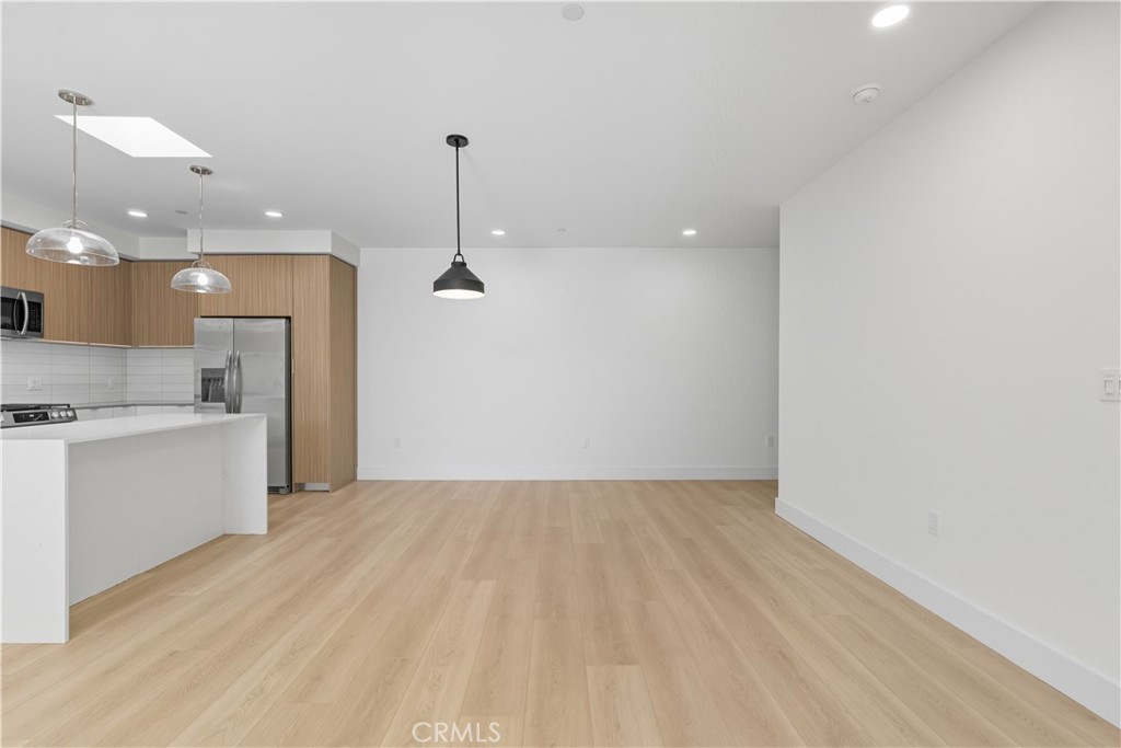 12078 Guerin Street, Unit 406 Studio City, CA 91604 - Photo 6 of 16 a view of a kitchen with a sink and a refrigerator