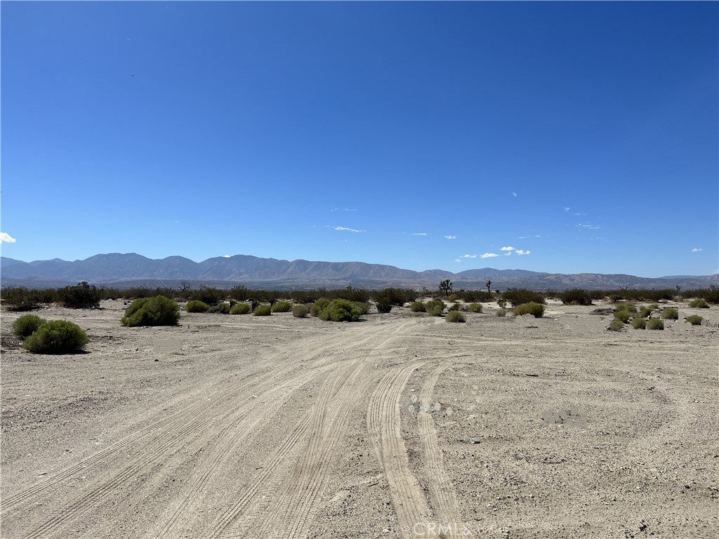 a view of an ocean beach and mountain