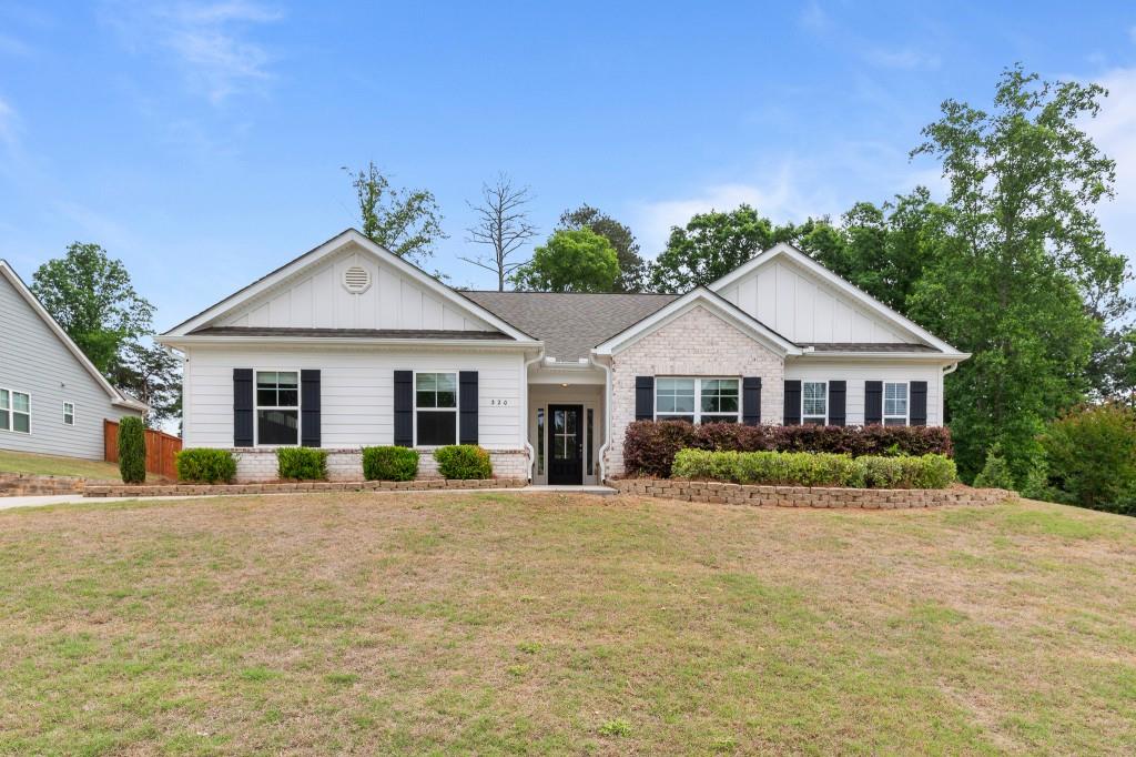 a front view of a house with a big yard
