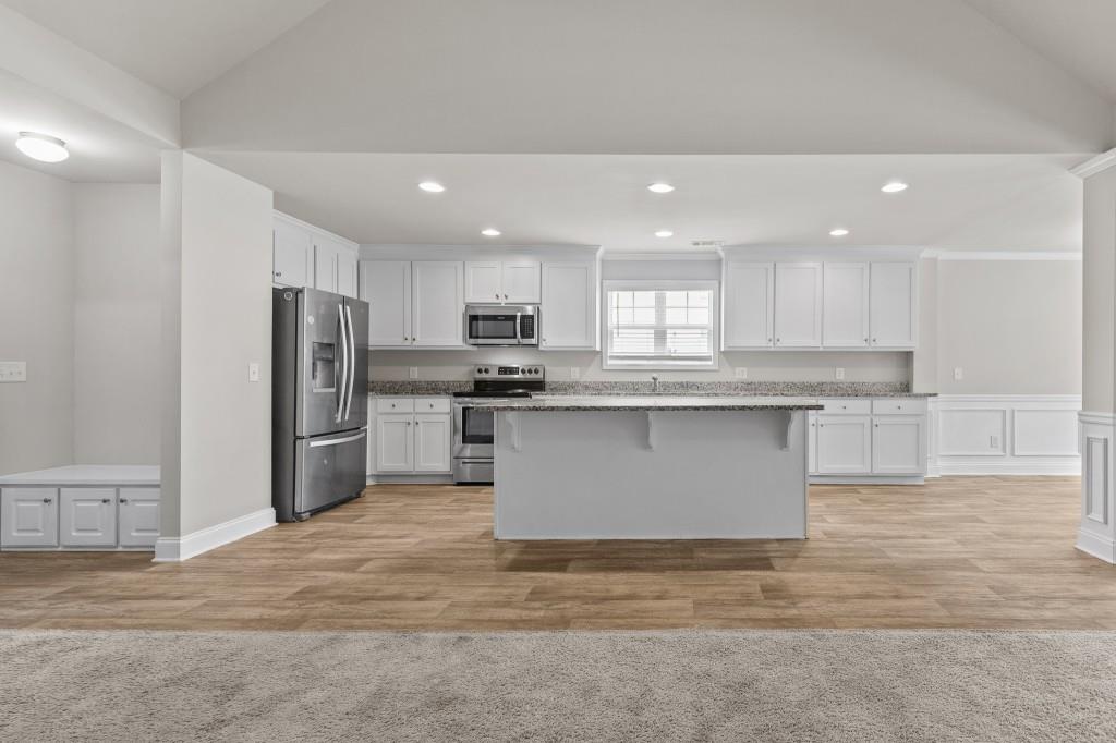 320 Lokeys Lane Bethlehem, GA 30620 - Photo 11 of 44 a kitchen with stainless steel appliances granite countertop a stove top oven a refrigerator and a sink