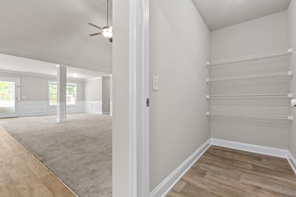 320 Lokeys Lane Bethlehem, GA 30620 - Photo 19 of 44 a view of a hallway with wooden floor and a bathroom