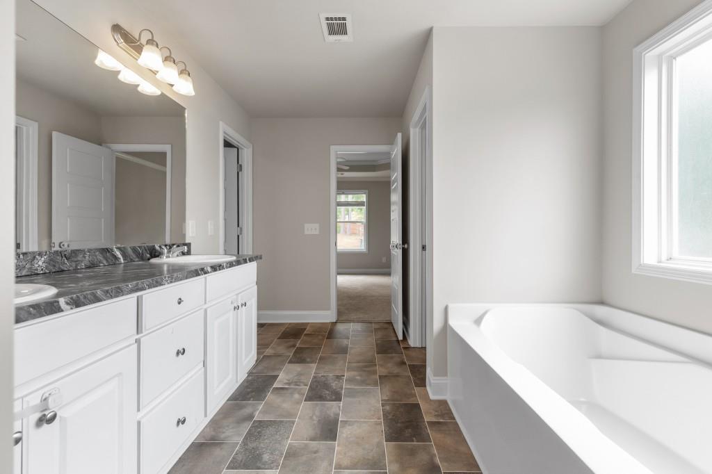 320 Lokeys Lane Bethlehem, GA 30620 - Photo 24 of 44 a spacious bathroom with a tub sink and mirror