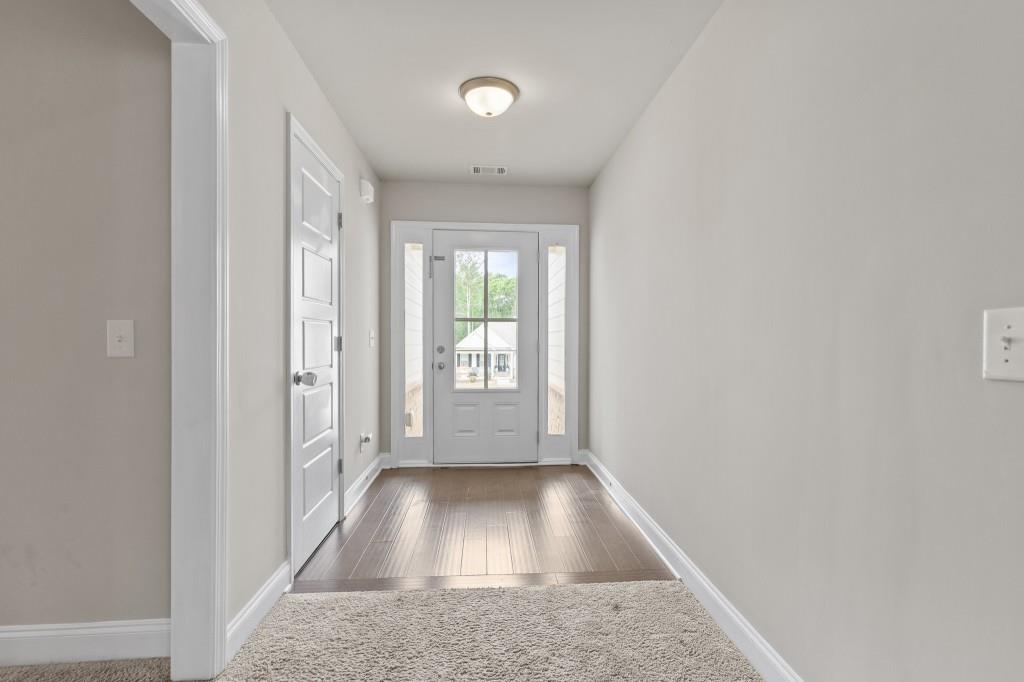 320 Lokeys Lane Bethlehem, GA 30620 - Photo 3 of 44 a view of a hallway with wooden floor and a living room