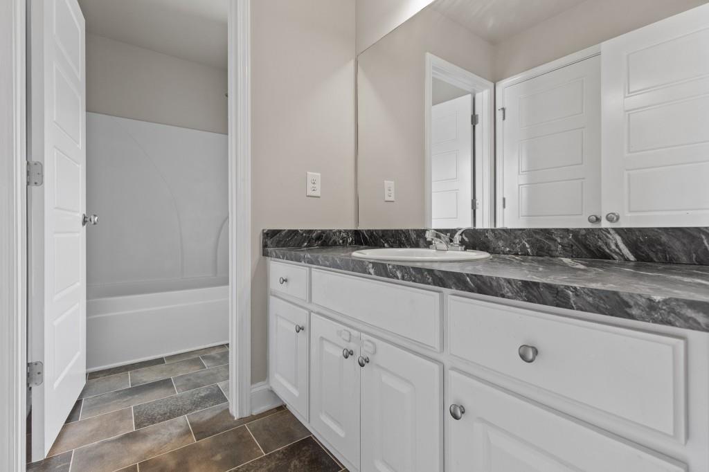 320 Lokeys Lane Bethlehem, GA 30620 - Photo 33 of 44 a bathroom with a granite countertop sink and white cabinets