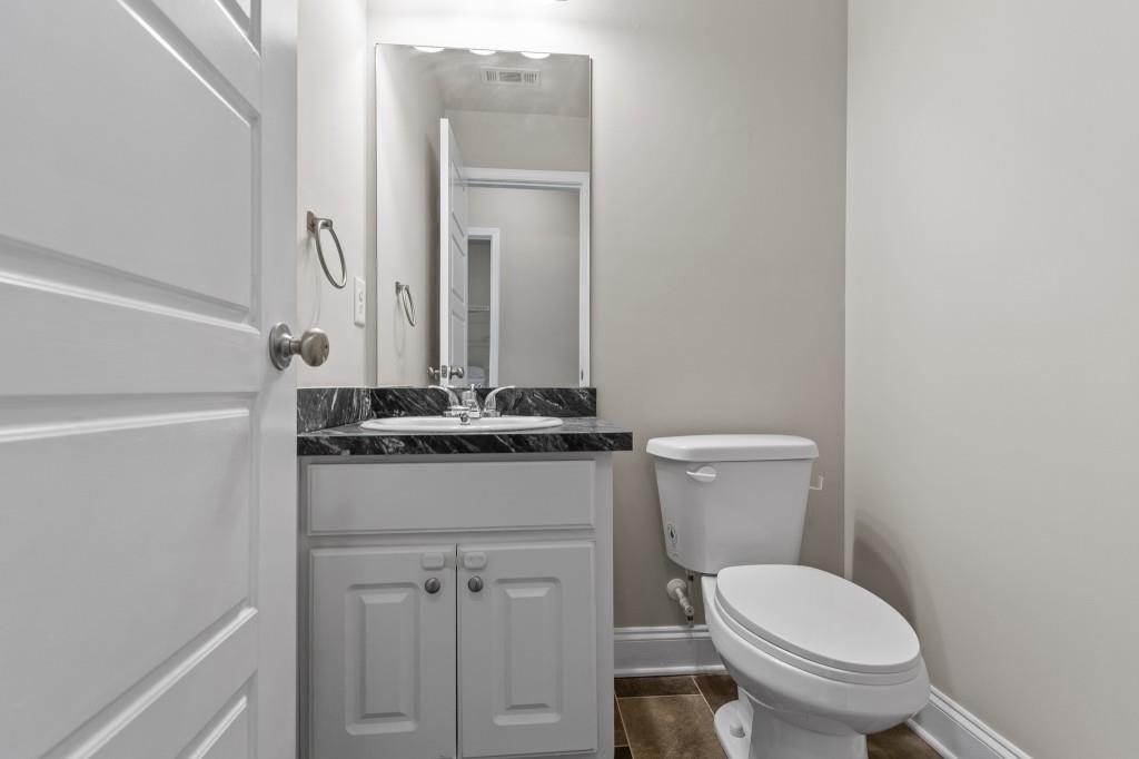 320 Lokeys Lane Bethlehem, GA 30620 - Photo 38 of 44 a bathroom with a toilet a sink and mirror