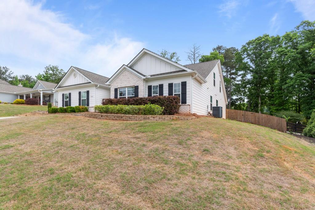 320 Lokeys Lane Bethlehem, GA 30620 - Photo 42 of 44 a front view of a house with a yard and potted plants