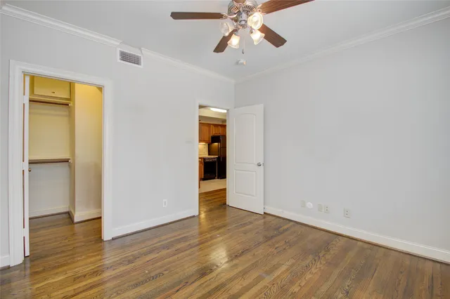 an empty room with wooden floor and closet