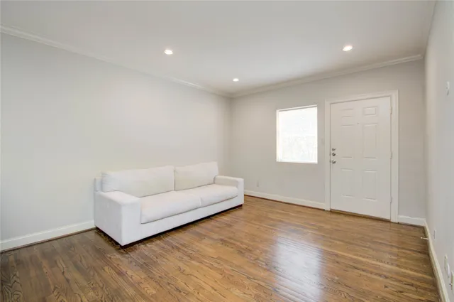 a living room with furniture and a hard wood floor