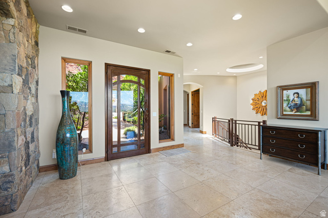 2331 West Entrada Trail, Unit 61 St. George, UT 84770 - Photo 7 of 69 Stone accent wall with recessed lighting, full-light entry door, and side windows
