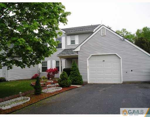 86 Woodbury Road Edison, NJ 08820 - Photo 1 of 6 a front view of a house with a yard and garage