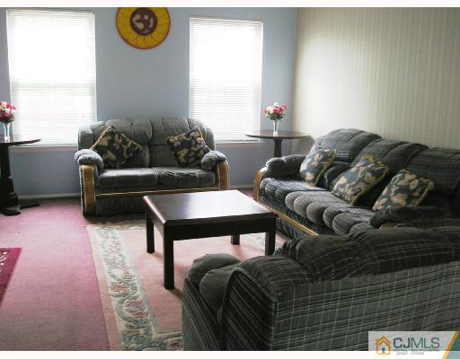 86 Woodbury Road Edison, NJ 08820 - Photo 2 of 6 a living room with furniture and a couch