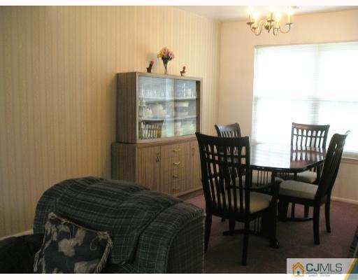 86 Woodbury Road Edison, NJ 08820 - Photo 3 of 6 a view of a dining room with furniture and wooden floor