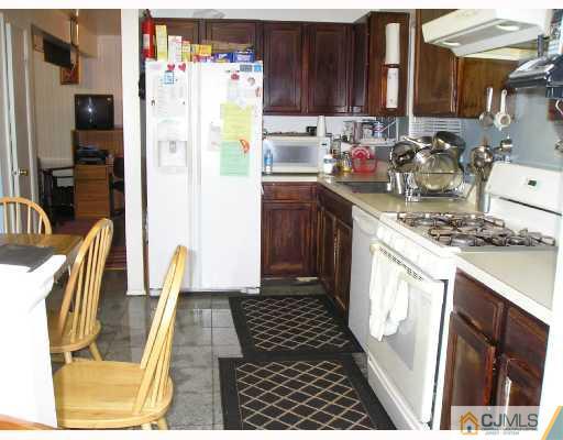 86 Woodbury Road Edison, NJ 08820 - Photo 4 of 6 a kitchen with stainless steel appliances granite countertop a refrigerator and a stove