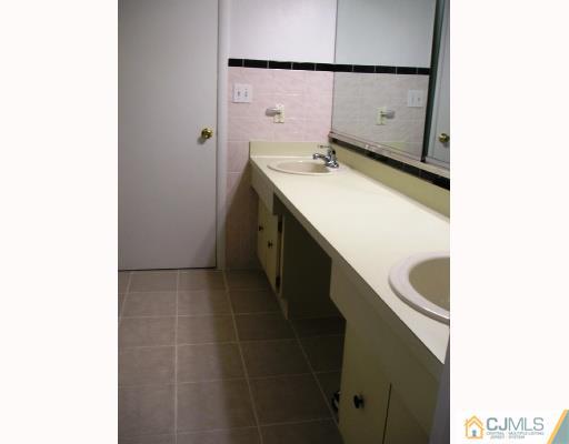 86 Woodbury Road Edison, NJ 08820 - Photo 5 of 6 a bathroom with a sink and mirror