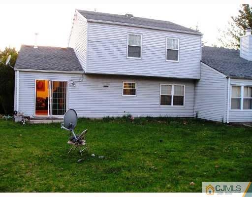 86 Woodbury Road Edison, NJ 08820 - Photo 6 of 6 a front view of a house with a garden