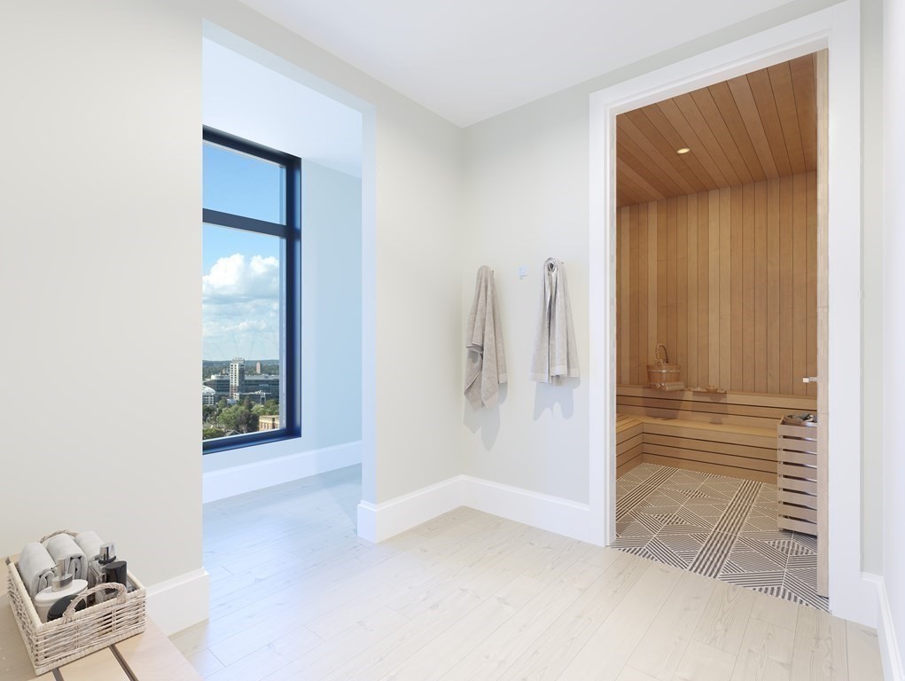 191 Washington Street, Unit 720 Boston, MA 02135 - Photo 15 of 29 a view of a hallway with wooden floor and a room