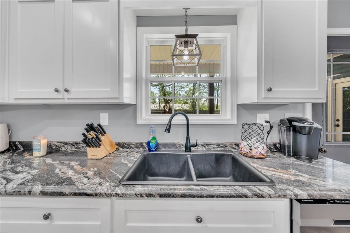 8 Valley Pond Lane Kelso, TN 37348 - Photo 18 of 75 a kitchen with granite countertop a sink stainless steel appliances white cabinets and a window