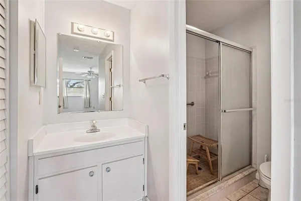 a bathroom with a sink a mirror and a shower