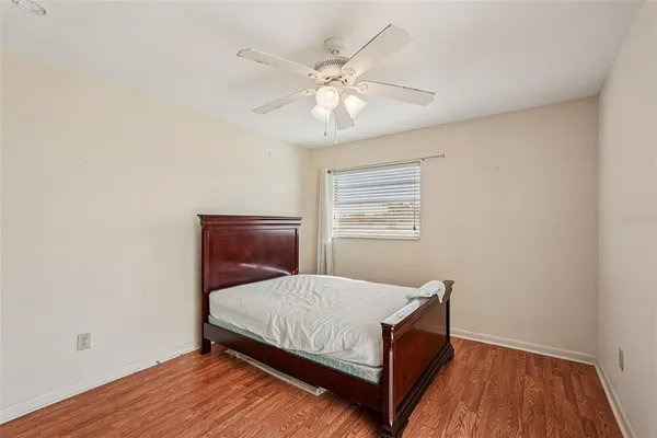 a bedroom with a bed and window