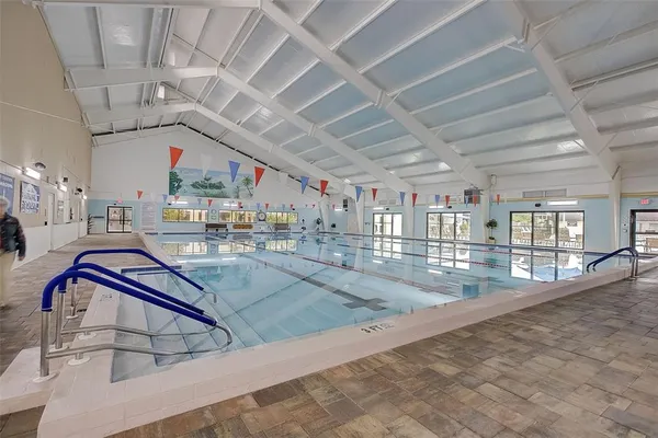 a front view of house with yard and swimming pool