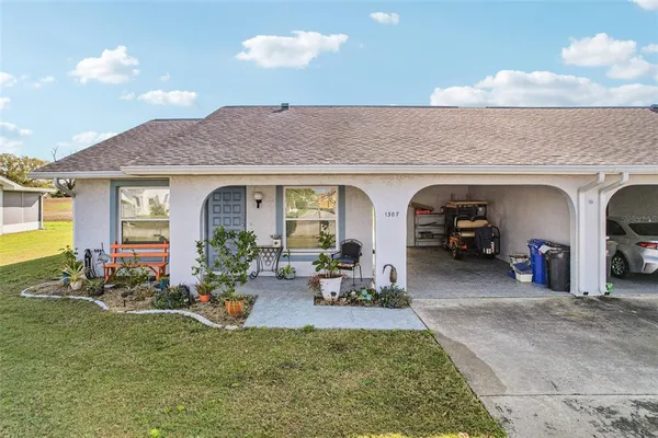 a front view of house with yard and green space