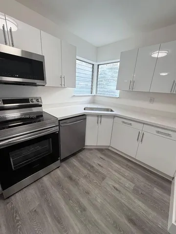 a kitchen with granite countertop a stove and a sink