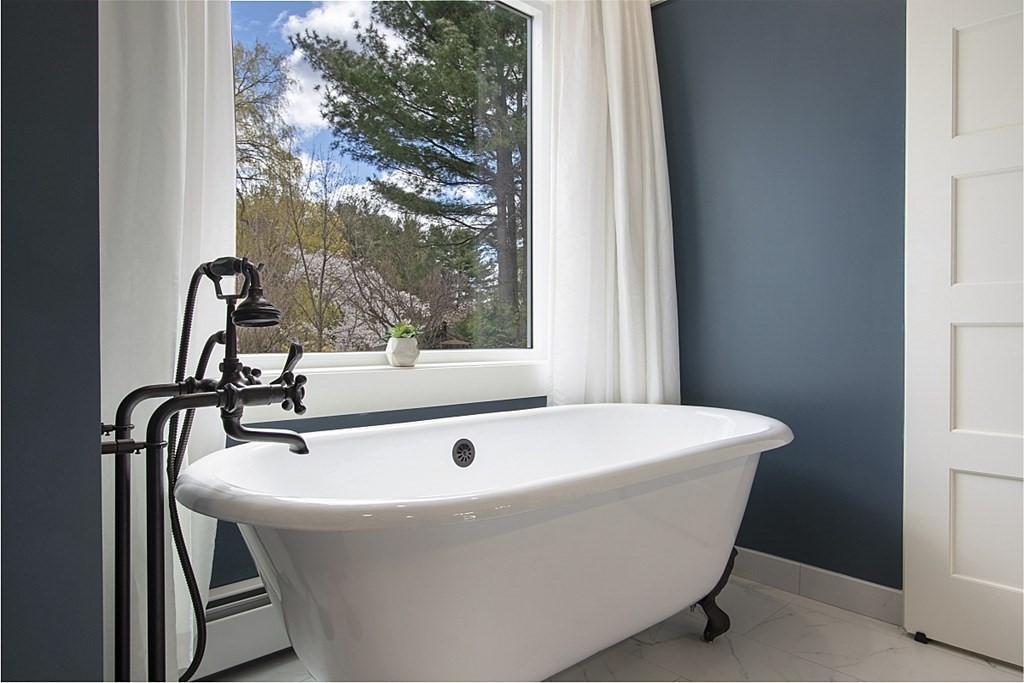 97 Argilla Road Andover, MA 01810 - Photo 20 of 42 a white bath tub sitting in a bathroom next to a window
