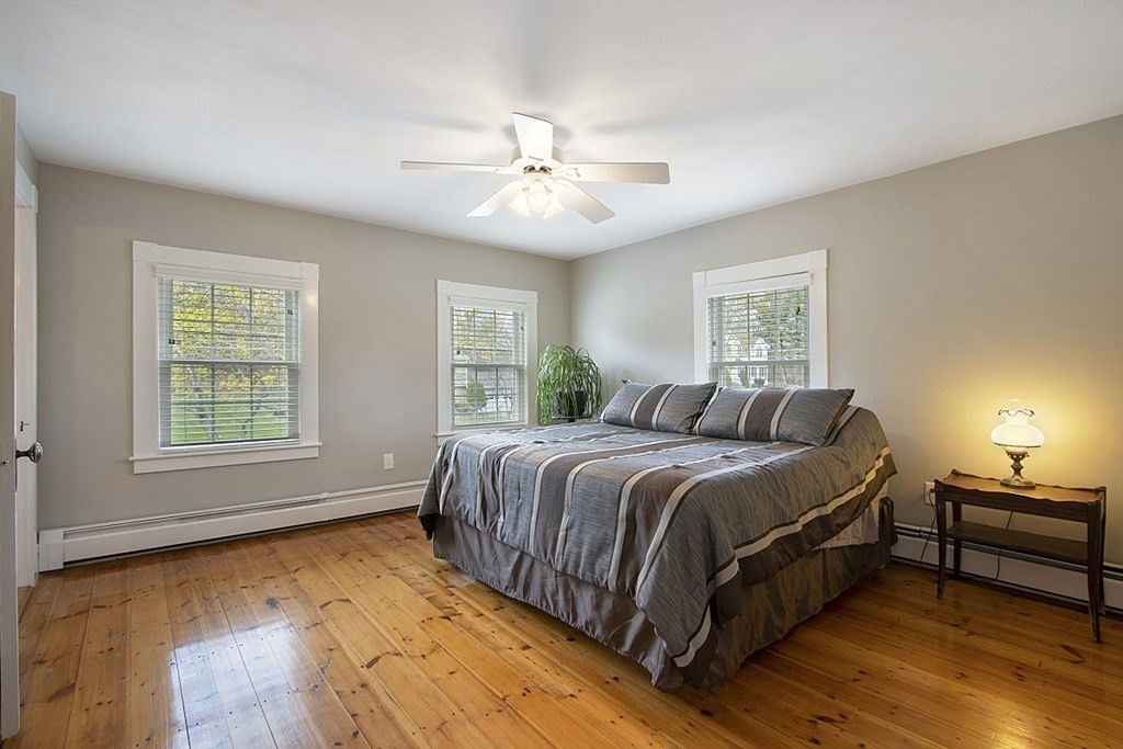 97 Argilla Road Andover, MA 01810 - Photo 21 of 42 a spacious bedroom with a bed and a chandelier