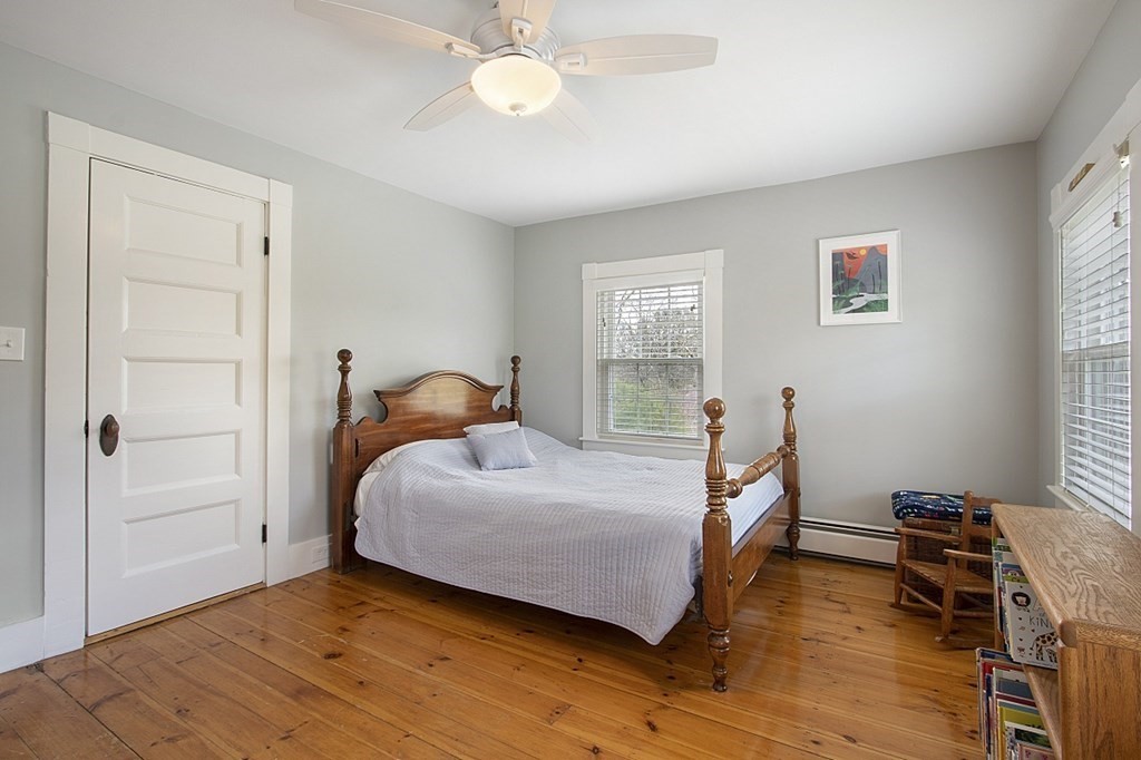 97 Argilla Road Andover, MA 01810 - Photo 23 of 42 a bedroom with a bed and wooden floor