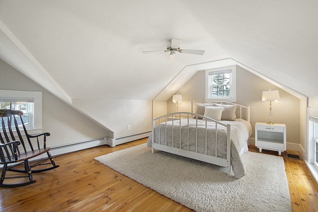 97 Argilla Road Andover, MA 01810 - Photo 24 of 42 a bedroom with a bed and a lamp on table