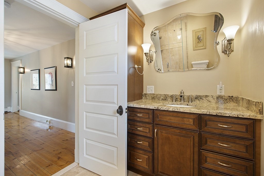 97 Argilla Road Andover, MA 01810 - Photo 25 of 42 a bathroom with a granite countertop sink vanity and mirror