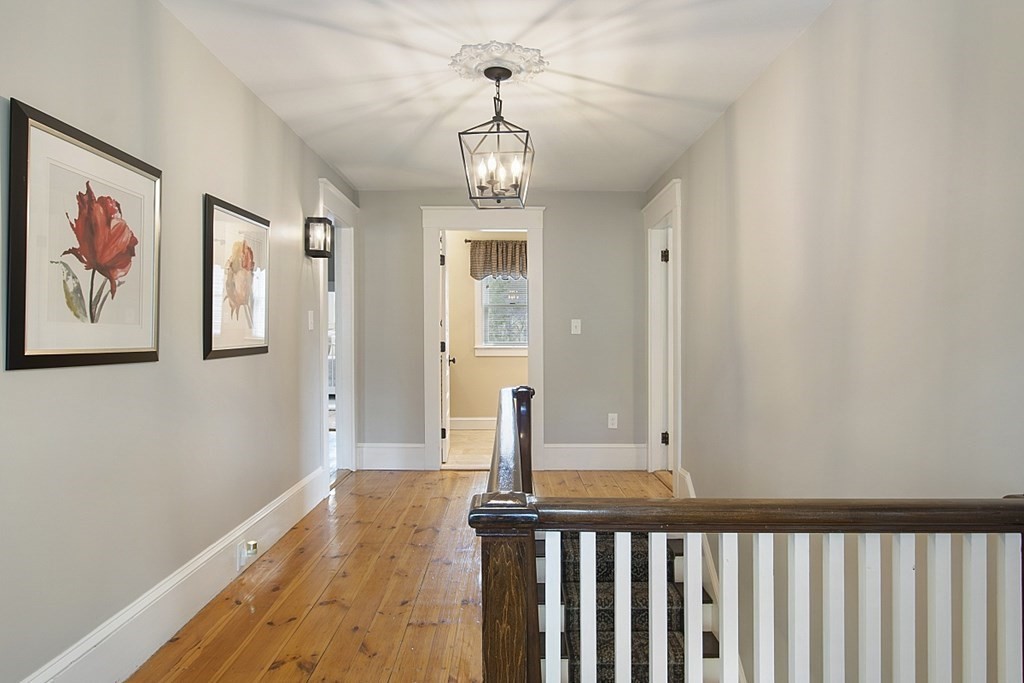 97 Argilla Road Andover, MA 01810 - Photo 27 of 42 a view of a hallway with wooden floor and staircase