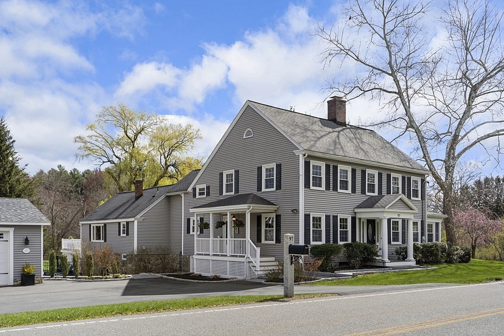 97 Argilla Road Andover, MA 01810 - Photo 29 of 42 a front view of a house with a garden and trees